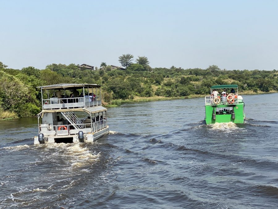 A couple enjoying a private boat safari on Kazinga Channel on a 7 day luxury honeymoon safari Uganda with private plunge pool lodges