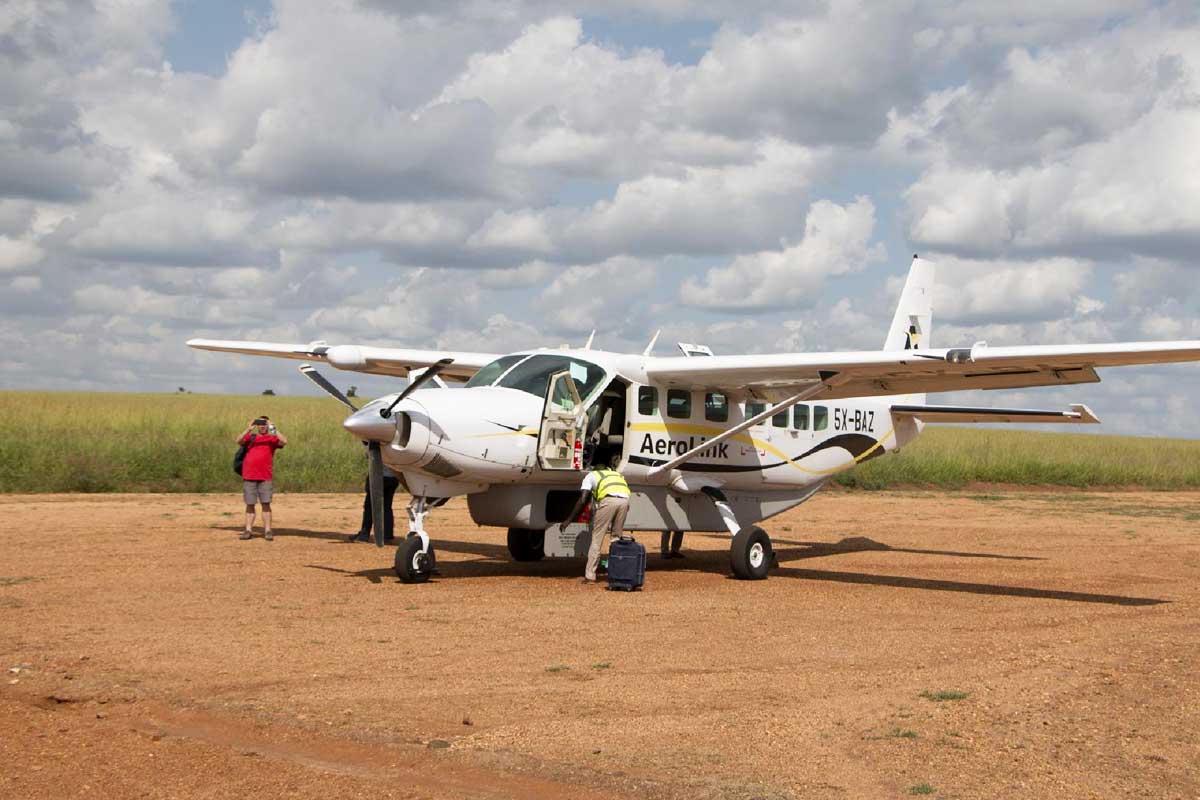 Aerolink flights Uganda vs driving safari parks – Aerolink plane at a Uganda airstrip