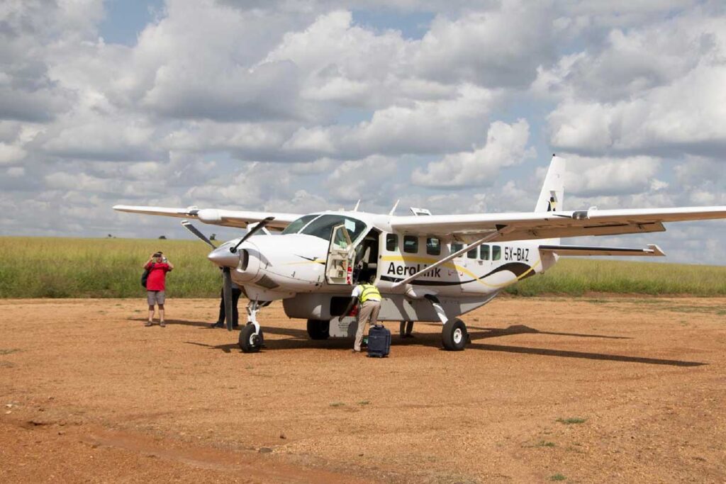 Aerolink flights Uganda vs driving safari parks – safari vehicle on a Ugandan road