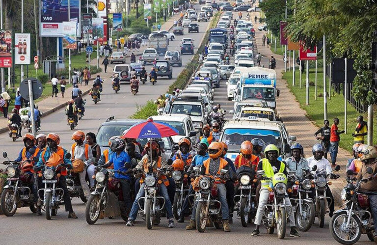 Boda Boda 101 Uganda guide – passenger wearing helmet on a motorcycle taxi in Kampala