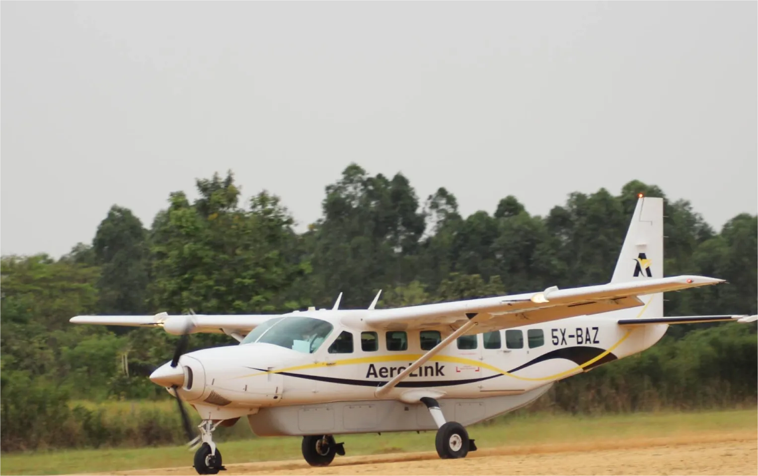 Cheapest domestic charter flights to Kisoro vs road drive - Aerolink aircraft landing at Kisoro airstrip