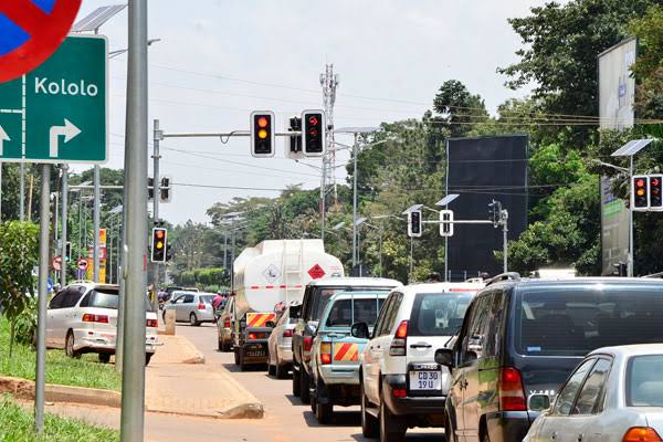 Driving in Kampala traffic foreign driver tips – busy Kampala street with cars and boda bodas