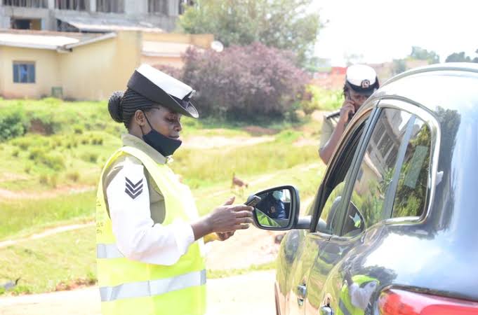 Driving in Uganda police bribe traffic stop – typical Ugandan highway with police presence