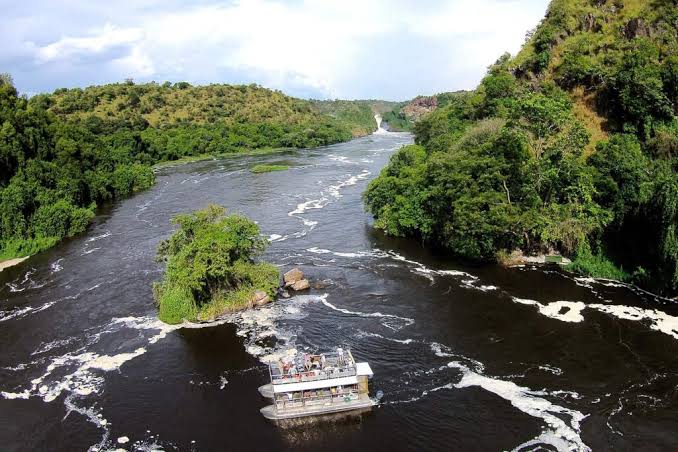 Driving Uganda rainy season safari tracks – crossing a small river during the rainy season