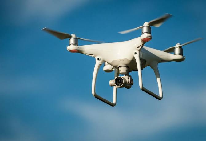 Drone permit regulations Uganda national parks CAA – drone flying over a Uganda national park