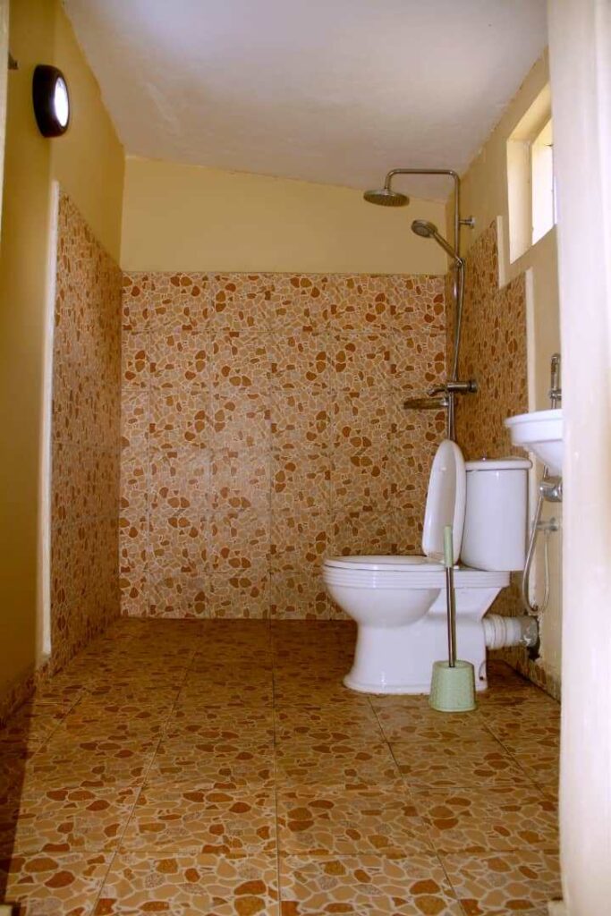 Hot water flush toilet facilities Uganda safari camps – hot water shower at a safari camp