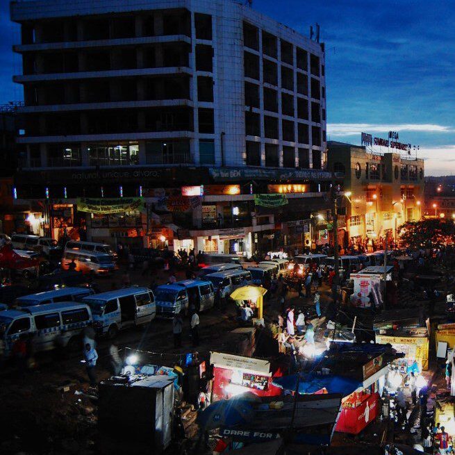 Kampala nightlife safety for tourists – Kampala city street lit up at night with people