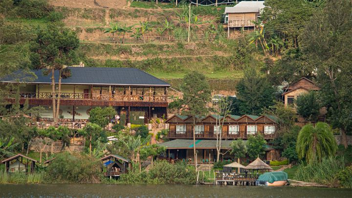 Digital nomad on a Zoom video call while working remotely from Uganda safari at a lodge in lake bunyonyi