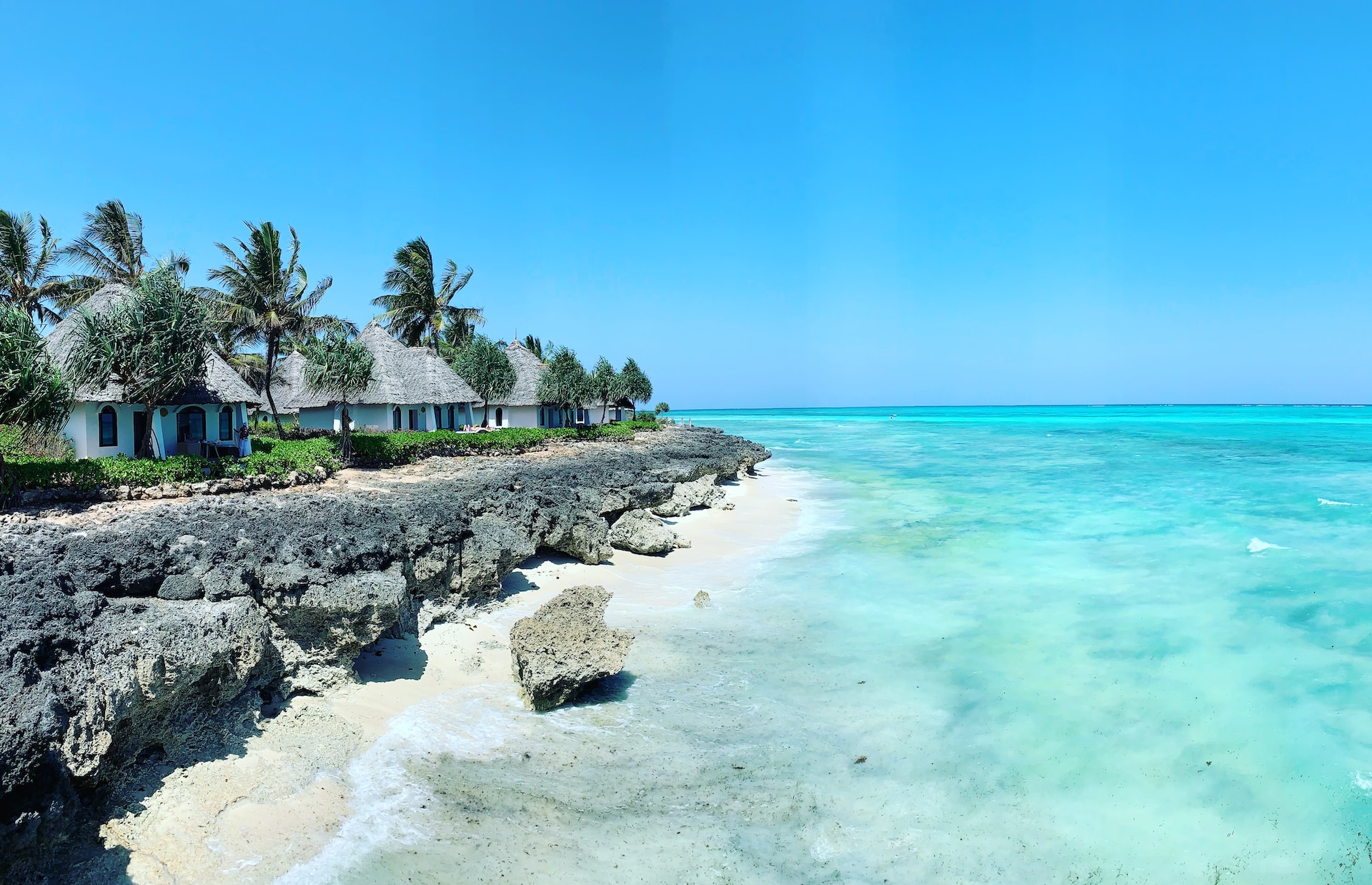 Pristine white-sand beaches in Zanzibar on a 14 day East Africa tour package Uganda gorillas Serengeti migration Zanzibar