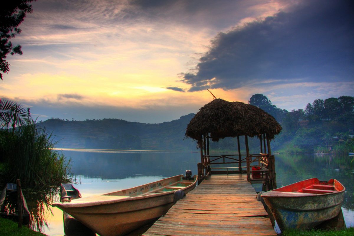 Canoe on Lake Bunyonyi at sunset, with terraced hills in the background