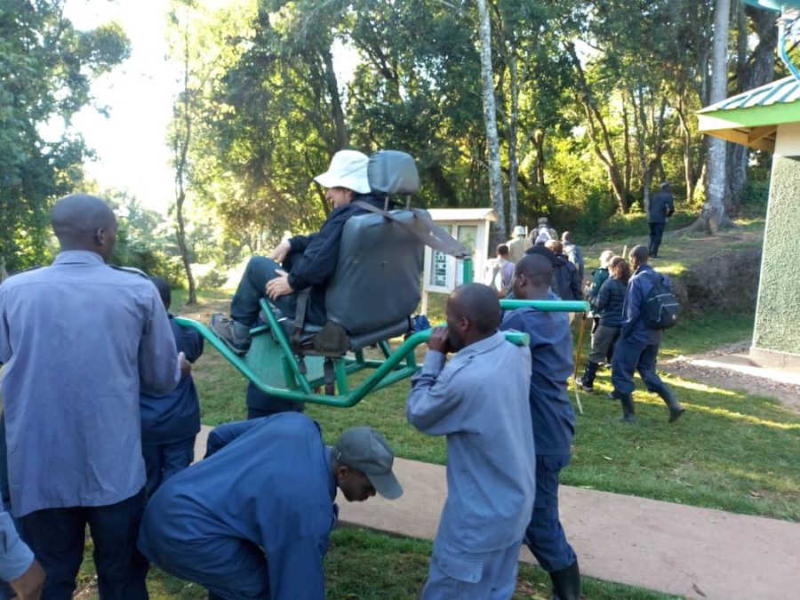 Sedan chair team carrying a trekker on the Bwindi forest trail