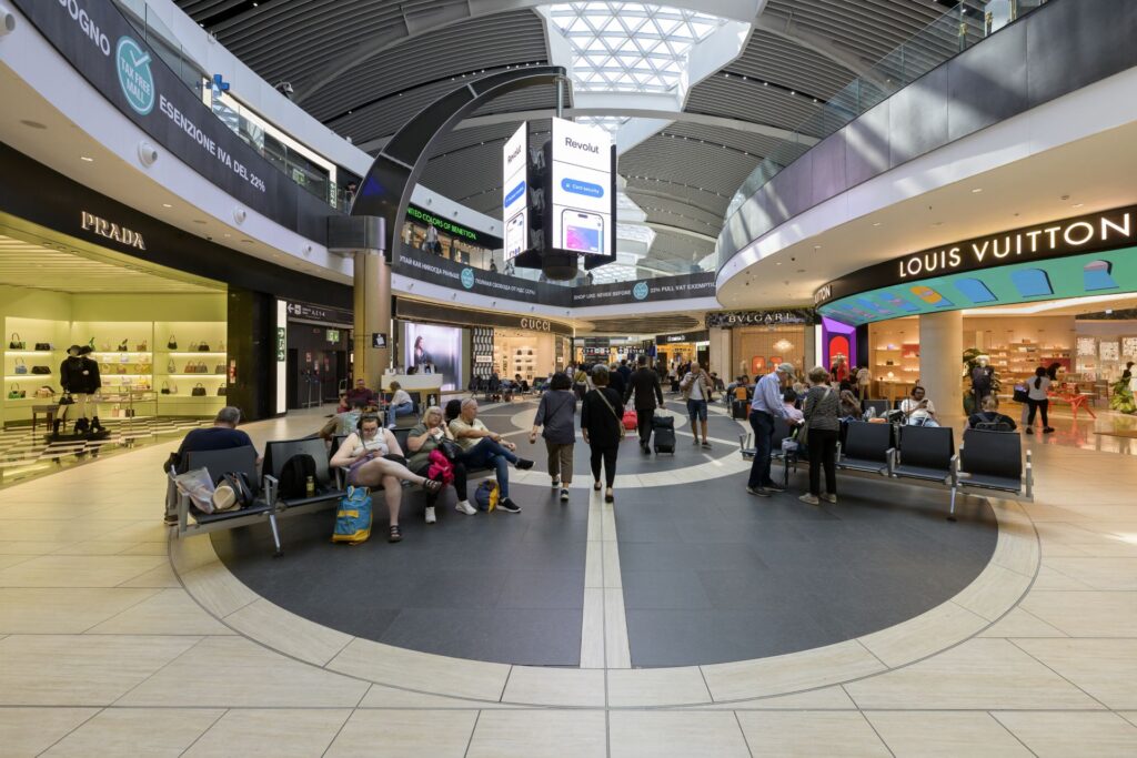 Travelers at Rome Fiumicino Airport before a Uganda safari from Italy