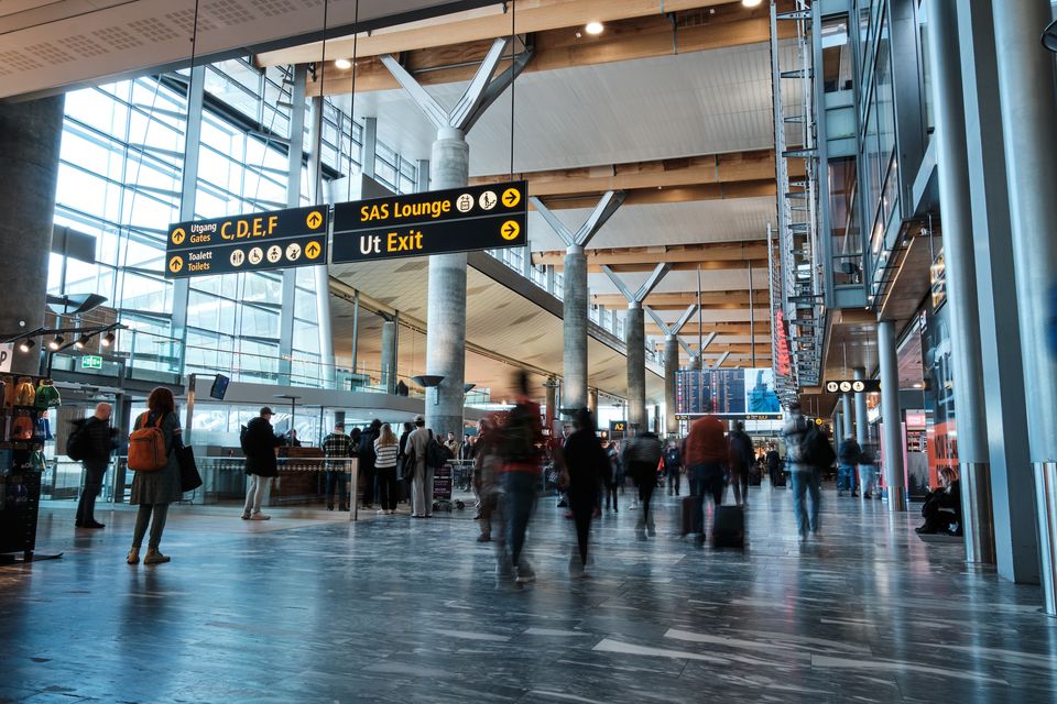 Travelers at Oslo Gardermoen Airport before a Uganda safari from Norway