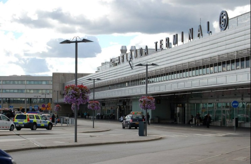 Travelers at Stockholm Arlanda Airport before a Uganda safari from Sweden